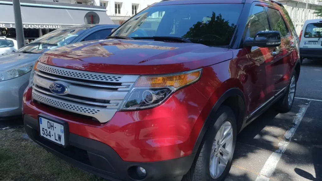 Red Ford Explorer SUV parked on a city street