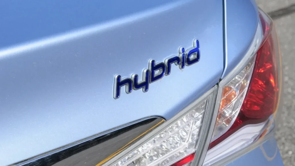 Hybrid badge on the rear of a light blue car